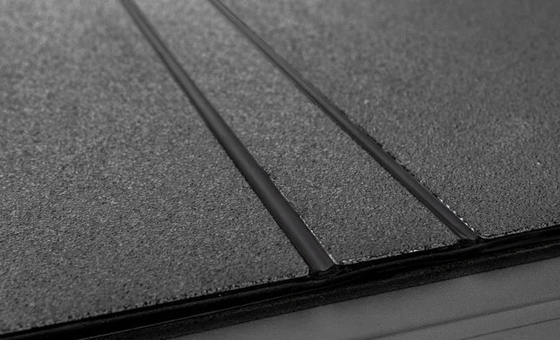 Access LOMAX Tri-Fold Cover Black Urethane Finish 22+ Toyota Tundra - 5ft 6in Bed - Back View