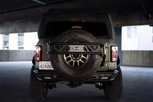 Load image into Gallery viewer, DV8 Offroad 21-23 Ford Bronco Spare Tire Guard & Accessory Mount - Additional View 11