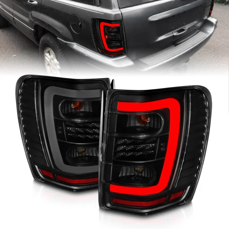 ANZO 1999-2004 Jeep Grand Cherokee LED Tail Lights w/ Light Bar Black Housing Smoke Lens - Main Product View