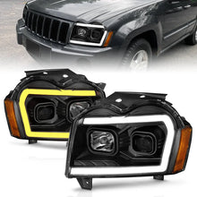 Load image into Gallery viewer, ANZO 2005-2007 Jeep Grand Cherokee Projector Headlights w/ Light Bar Switchback Black Housing - Main Product View