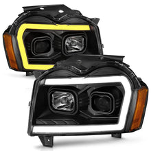 Load image into Gallery viewer, ANZO 2005-2007 Jeep Grand Cherokee Projector Headlights w/ Light Bar Switchback Black Housing - Installation View