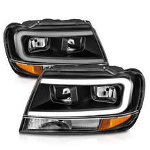 Load image into Gallery viewer, ANZO 99-04 Jeep Grand Cherokee Crystal Headlights - w/ Light Bar Black Housing - Installation View