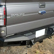 Load image into Gallery viewer, Addictive Desert Designs HoneyBadger Rear Bumper w/ Tow Hooks fits 2010-2014 Ford F-150 Raptor, F-150 SVT Raptor, F-150 FX...