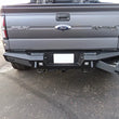 Load image into Gallery viewer, Addictive Desert Designs HoneyBadger Rear Bumper w/ Tow Hooks fits 2010-2014 Ford F-150 Raptor, F-150 SVT Raptor, F-150 FX...