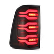 Load image into Gallery viewer, AlphaRex 19-21 Dodge Ram 1500 Luxx-Series LED Tail Lights Black/Red w/Activ Light/Seq Signal - Back View