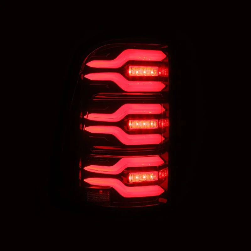 AlphaRex 19-21 Dodge Ram 1500 Luxx-Series LED Tail Lights Black/Red w/Activ Light/Seq Signal - Installation View