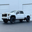 Load image into Gallery viewer, Cognito 20-24 Chevy/GMC Silv/Sierra 2500/3500 HD 2WD/4WD 4in Perf Lift Kit w/ Fox PSRR 2.0 Shocks - Side View