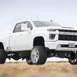 Load image into Gallery viewer, Cognito 20-24 Chevy/GMC Silv/Sierra 2500/3500 HD 2WD/4WD 7in Perf Lift Kit w/ Fox PSRR 2.0 Shocks - Installation View