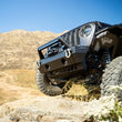 Load image into Gallery viewer, DV8 Offroad 18-23 Jeep Wrangler JL/JT Front Bumper Sway-Bar Disconnect Motor Skid Plate - Back View