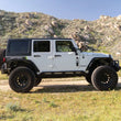 Load image into Gallery viewer, DV8 Offroad 2007-2018 Jeep Wrangler JK 4-Door Rock Sliders - Installation View