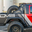 Load image into Gallery viewer, DV8 Offroad 2019+ Jeep Gladiator Universal Stand Up In-Bed Tire Carrier - Installation View