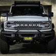 Load image into Gallery viewer, DV8 Offroad 21-22 Ford Bronco Factory Front Bumper Licence Relocation Bracket - Front - Side View