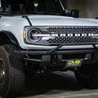 Load image into Gallery viewer, DV8 Offroad 21-22 Ford Bronco Factory Front Bumper Licence Relocation Bracket - Front - Additional View 7