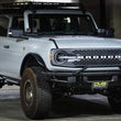 Load image into Gallery viewer, DV8 Offroad 21-22 Ford Bronco Factory Front Bumper Licence Relocation Bracket - Front - Additional View 16