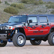 Load image into Gallery viewer, Fabtech 03-08 Hummer H2 Suv/Sut 4WD w/Rr Coil Springs 6in Perf Sys w/Perf Shks - Side View