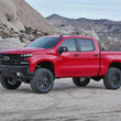 Load image into Gallery viewer, Fabtech 19-20 GM C/K1500 P/U w/Trail Boss/At4 Pkg 4in Perf Sys w/Dl 2.5 Resi &amp; 2.25 - Side View
