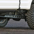 Load image into Gallery viewer, Fabtech 2023+ Ford F250/F350 4WD Super Duty Floating Rear Traction Bar System - Side View
