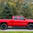 Load image into Gallery viewer, Fishbone Offroad 07-18 Chevrolet Silverado 1500/2500/3500 Double Cab Oval Side Steps -Black Textured - Back View