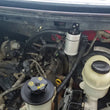Load image into Gallery viewer, J&amp;L 05-10 Ford F-150 5.4L Driver Side Oil Separator 3.0 - Clear Anodized - Side View
