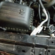 Load image into Gallery viewer, J&amp;L 09-18 Ram 1500 5.7L Passenger Side Oil Separator 3.0 - Clear Anodized - Side View