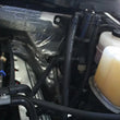 Load image into Gallery viewer, J&amp;L 11-17 Ford F-150 5.0L / 11-14 Ford F-150 6.2L Driver Side Oil Separator 3.0- Black Anodized - Side View