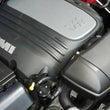 Load image into Gallery viewer, J&amp;L 11-25 Jeep Grand Cherokee 5.7L Passenger Side Oil Separator 3.0 - Black Anodized - Side View
