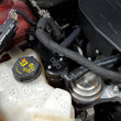Load image into Gallery viewer, J&amp;L 13-19 Ford Fusion 1.5L EcoBoost Oil Separator 3.0 Passenger Side - Black Anodized - Side View