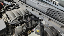 Load image into Gallery viewer, J&amp;L 14-18 Chevy Silverado 1500 / 14-18 GMC Sierra 1500 4.3L V6 Oil Separator - Black Anodized - Side View
