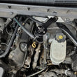 Load image into Gallery viewer, J&amp;L 14-18 Chevy Silverado 1500 / 14-18 GMC Sierra 1500 4.3L V6 Oil Separator - Black Anodized - Detail View