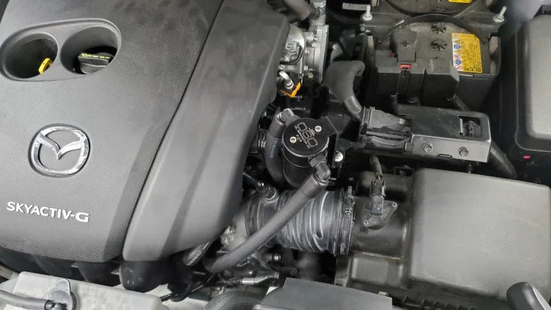 J&L 14-24 Mazda CX5 2.5L Non-turbo Driver Side 3.0 Oil Separator Kit - Black Anodized - Side View
