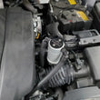 Load image into Gallery viewer, J&amp;L 14-24 Mazda CX5 2.5L Non-turbo Driver Side 3.0 Oil Separator Kit - Clear Anodized - Side View