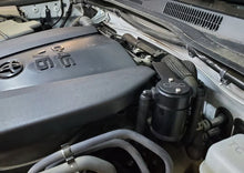 Load image into Gallery viewer, J&amp;L 16-23 Toyota Tacoma 3.5L Driver Side Oil Separator 3.0 - Black Anodized - Side View