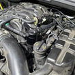 Load image into Gallery viewer, J&amp;L 16-24 Dodge Durango / Jeep Grand Cherokee 3.6L Oil Separator 3.0 Passenger Side - Black Anod - Side View
