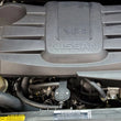 Load image into Gallery viewer, J&amp;L 16-24 Nissan Titan 5.6L Passenger Side Oil Separator 3.0 - Black Anodized - Side View