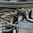 Load image into Gallery viewer, J&amp;L 17-24 Nissan Armada / 14-24 Infiniti QX80 5.6L Driver Side Oil Separator 3.0 - Clear Anodize - Side View