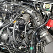 Load image into Gallery viewer, J&amp;L 19-24 Ford/Lincoln SUV &amp; Trucks w 2.0 EcoBoost Driver Side Oil Separator 3.0 - Black Ano - Side View
