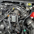 Load image into Gallery viewer, J&amp;L 19-24 Ford/Lincoln SUVs &amp; Trucks w 2.0 EcoBoost Driver Side Oil Separator 3.0 - Clear An - Side View