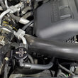 Load image into Gallery viewer, J&amp;L 2015-2017 Ford Expedition 3.5L EcoBoost Oil Separator 3.0 - Black Anodized - Side View