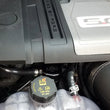 Load image into Gallery viewer, J&amp;L 2018-2023 Ford Mustang GT Passenger Side Oil Separator 3.0 - Black Anodized - Installation View