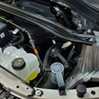 Load image into Gallery viewer, J&amp;L 2020-2024 Ford Explorer 2.3L EcoBoost Driver Side Oil Separator 3.0 - Clear Anodized - Side View