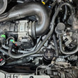 Load image into Gallery viewer, J&amp;L 2025 Ford Transit 150/250/350 3.5L Oil Separator - Black Anodized - Side View