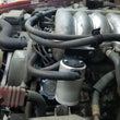 Load image into Gallery viewer, J&amp;L 95-04 Toyota Tacoma/4Runner 3.4L Driver Side Oil Separator 3.0 - Clear Anodized - Side View