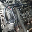 Load image into Gallery viewer, J&amp;L 97-13 Chevy/GM Truck/SUV 4.8L/5.3L/6.0L/6.2L Driver Side Oil Separator 3.0 - Clear Anodized - Side View