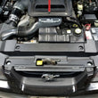Load image into Gallery viewer, JLT 99-04 Ford Mustang Black Textured Radiator Support Cover - Side View