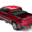Load image into Gallery viewer, Lund 04-15 Nissan Titan (5.5ft. Bed) Hard Fold Tonneau Cover w/Bracket Kit - Black - Back View