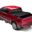 Load image into Gallery viewer, Lund 07-13 Chevy Silverado 1500 (6.5ft. Bed) Genesis Tri-Fold Tonneau Cover - Black - Back View
