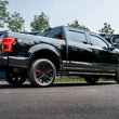 Load image into Gallery viewer, MBRP 15-20 Ford F150 Pre-Axle 4in OD Tips Dual Outlet 3in Black Coated Cat Back Exhaust - Installation View
