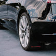 Load image into Gallery viewer, Rally Armor 17-23 Tesla Model 3 Black UR Mud Flap w/White Logo - Installation View