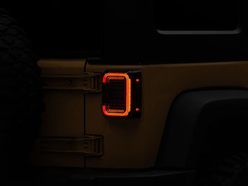 Raxiom 07-18 Jeep Wrangler JK Axial Series LED Halo Tail Lights- Black Housing (Dark Smoked Lens) - Main Product View