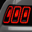 Load image into Gallery viewer, Raxiom 99-04 Ford Mustang Excluding 99-01 Cobra Icon LED Tail Lights- Black Housing (Smoked Lens) - Main Product View